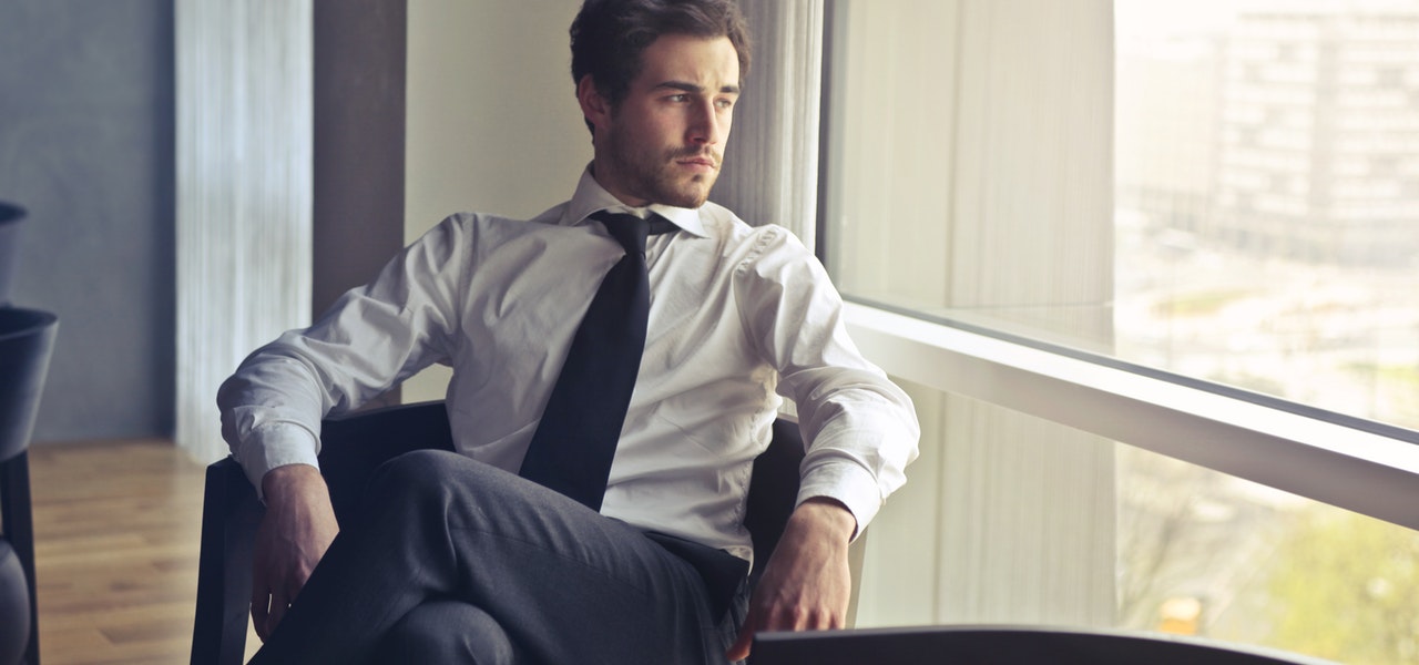 Man sitting wearing tie
